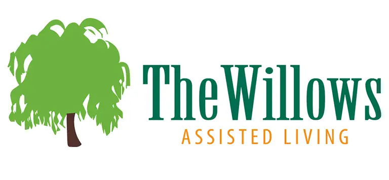 Logo for The Willows Assisted Living features a green willow tree on the left, with the business name in green and orange text, reflecting compassionate senior care on a clean white background.