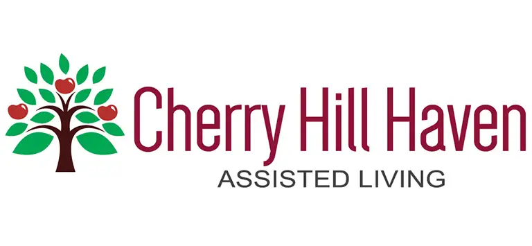 Logo for Cherry Hill Haven Assisted Living in Kalkaska featuring a stylized tree with green leaves and red apples next to the business name in maroon text.