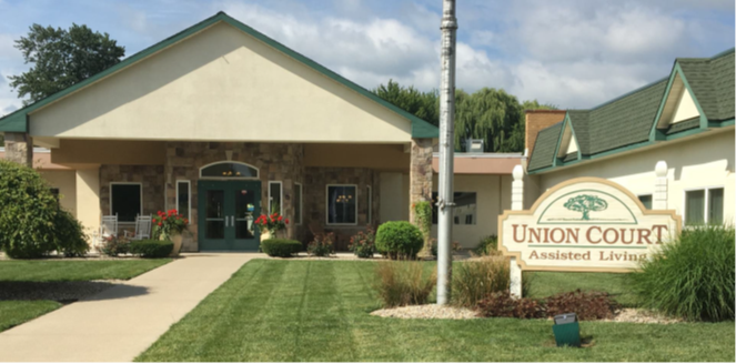 Single-story assisted living facility with green trim and manicured lawn, operated by Baruch Senior Ministries, featuring a sign reading "Union Court Assisted Living" near the entrance—part of reputable senior living communities.