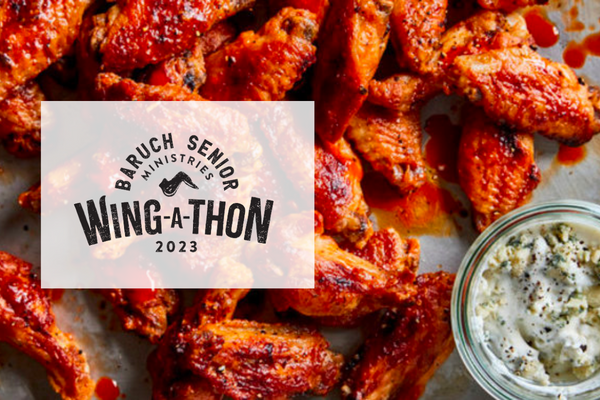 A tray of sauced chicken wings with a glass bowl of dip beside them, overlaid with the Baruch Senior Ministries Wing-A-Thon 2023 Fundraiser event logo.