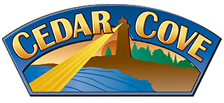 Cedar Cove Assisted Living logo featuring bold yellow text, a lighthouse with light beams, trees, and a body of water in the background.