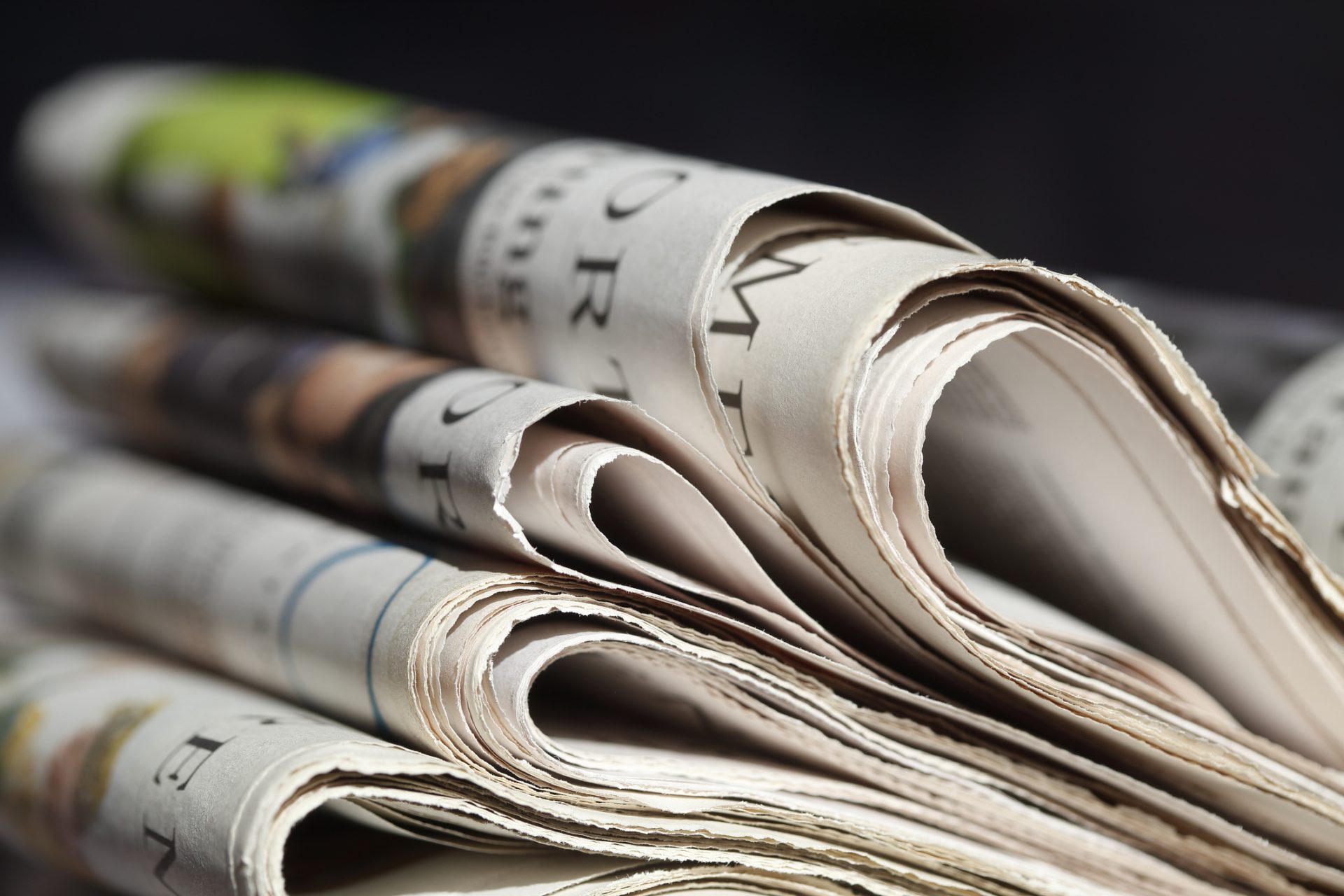 A close-up view of several folded newspapers stacked on top of each other, featuring printed text and images—perfect for highlighting updates in the May Newsletter from Baruch Senior Ministries.
